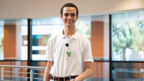 young male intern standing in ITT facility